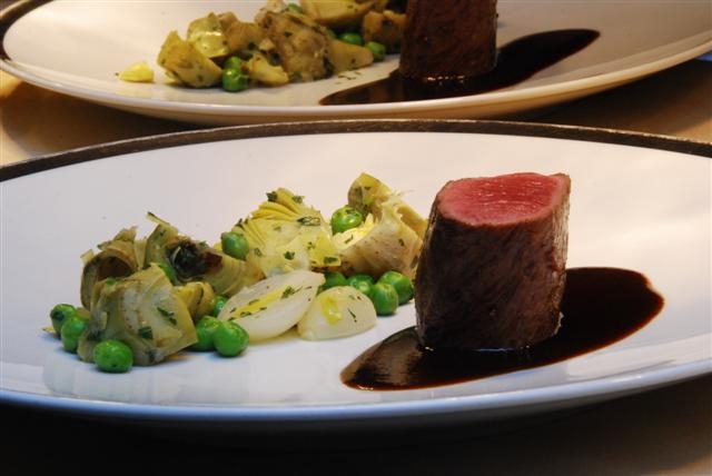 Medallion of Colorado Lamb with Pearl Omions, Artichokes, English Peas, Acai Jus