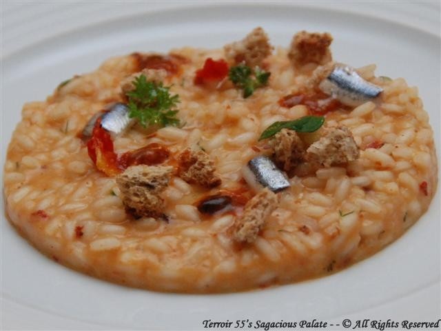 Risotto with sea urchins and anchovies sauce, tomato water and wild fennel scented croutons