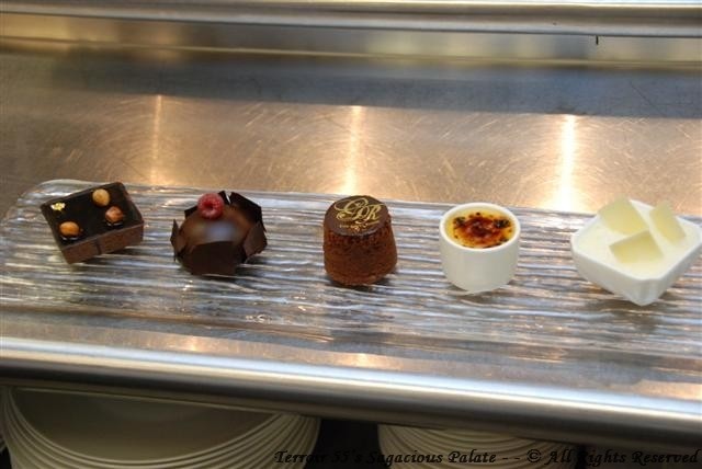 Dessert medley: Hazelnut praline tart, chocolate sphere with chocolate mousse and raspberry preserves, chocolate molten lava cake, vanilla creme brulee and white chocolate mousse.