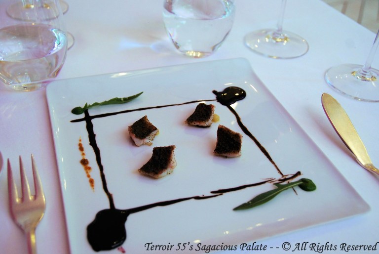 Red mullet gratinated with caper powder from our organic farm, black garlic cream, reduction of red wine and rocket